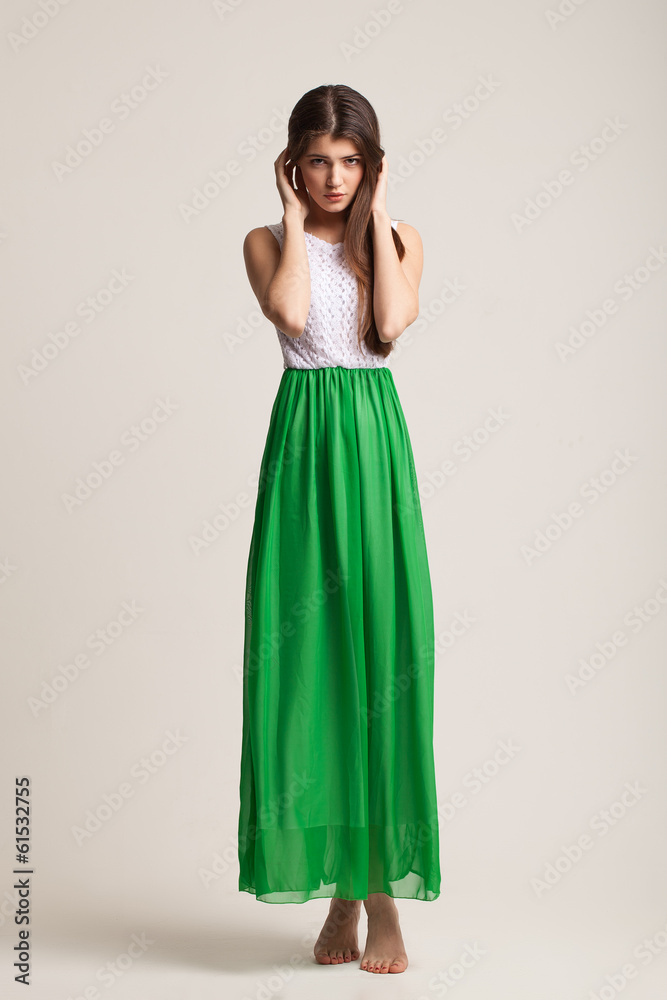 The young girl poses in studio. Clothes advertizing. Catalog. Po