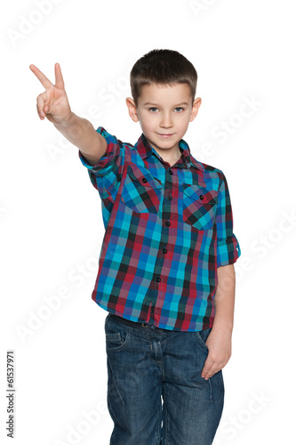 Fashion little boy shows victory sign