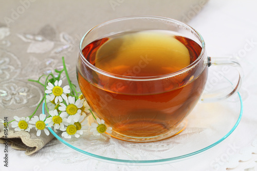 Tea and fresh chamomile flowers
