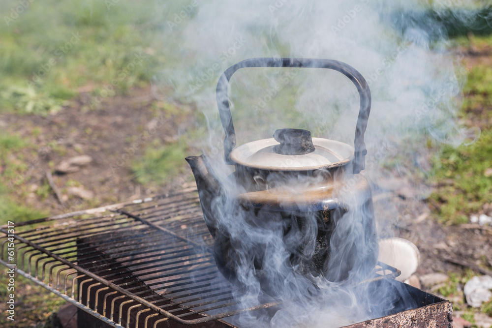 Kettle boiling over gas burner on the nature Kettle boiling over gas burner on the nature