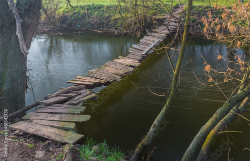 landscape with a wooden bridge over the river
