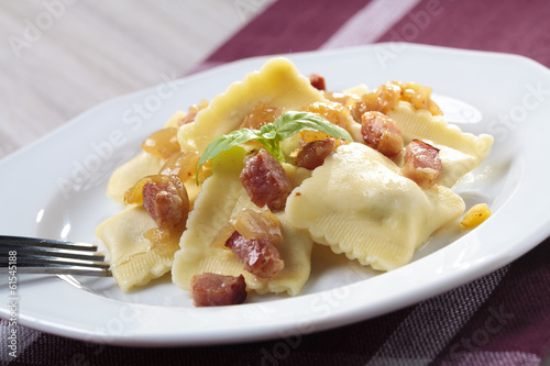 Portion of ravioli with onion and bacon