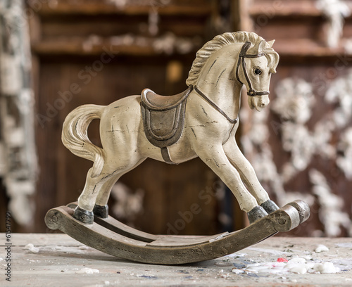 Vintage old rocking horse on a wooden background