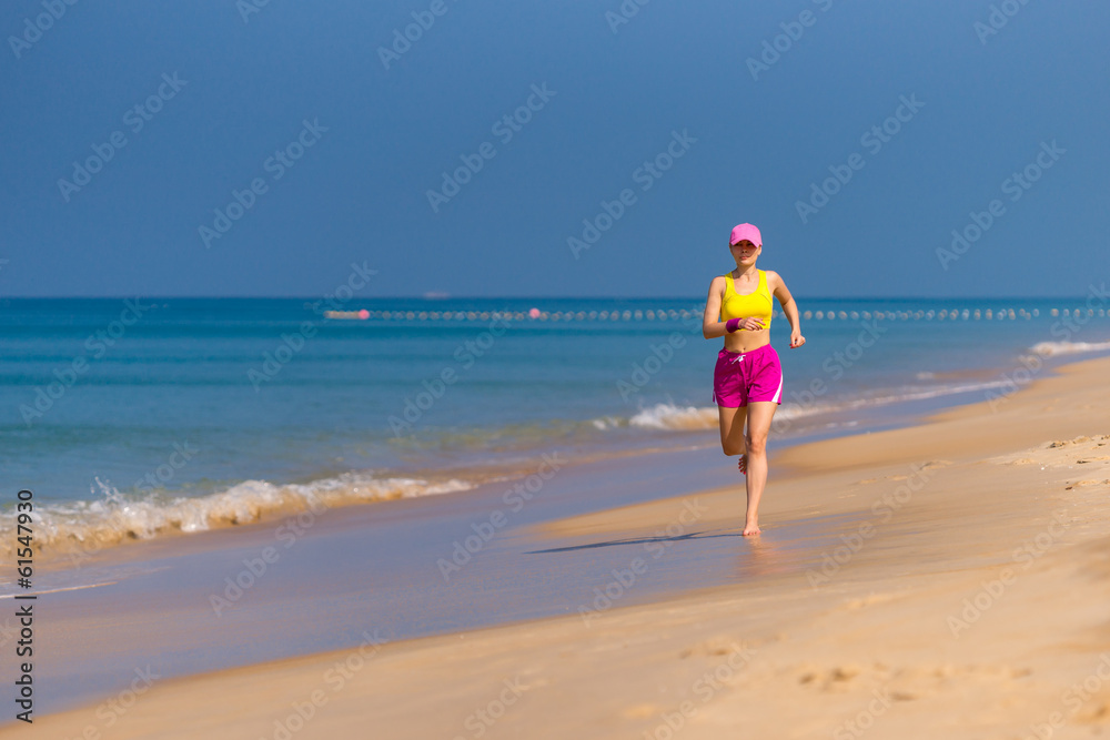 Healthy Woman running on beach