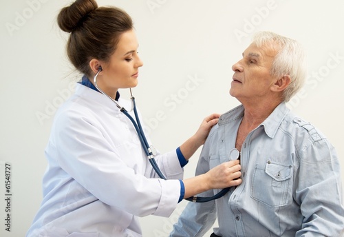 Senior man and doctor woman with stethoscope