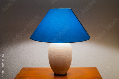 Lit bedside lamp over nightstand