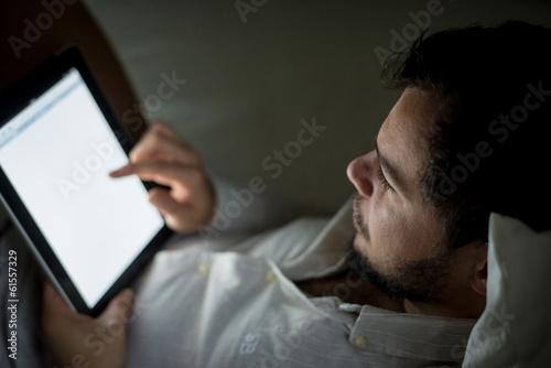 young stylish man using tablet