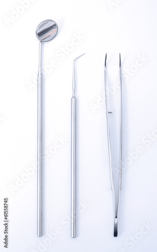 Row of various dental tools on white