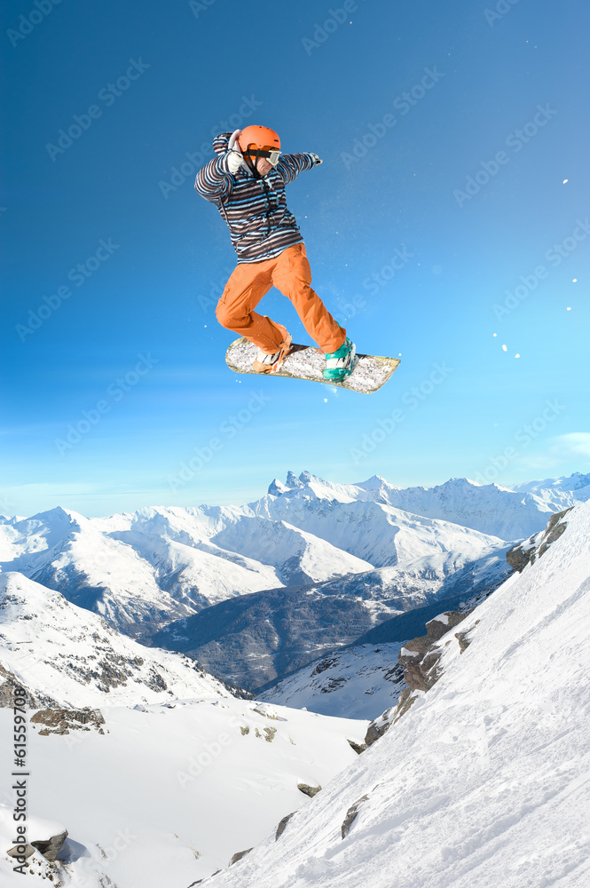 Extreme snowboarding man jumping high in the air