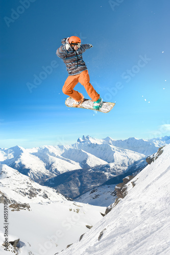 Extreme snowboarding man jumping high in the air