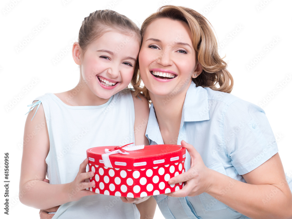 happy white mother and young daughter hold present happy white mother and young daughter hold present