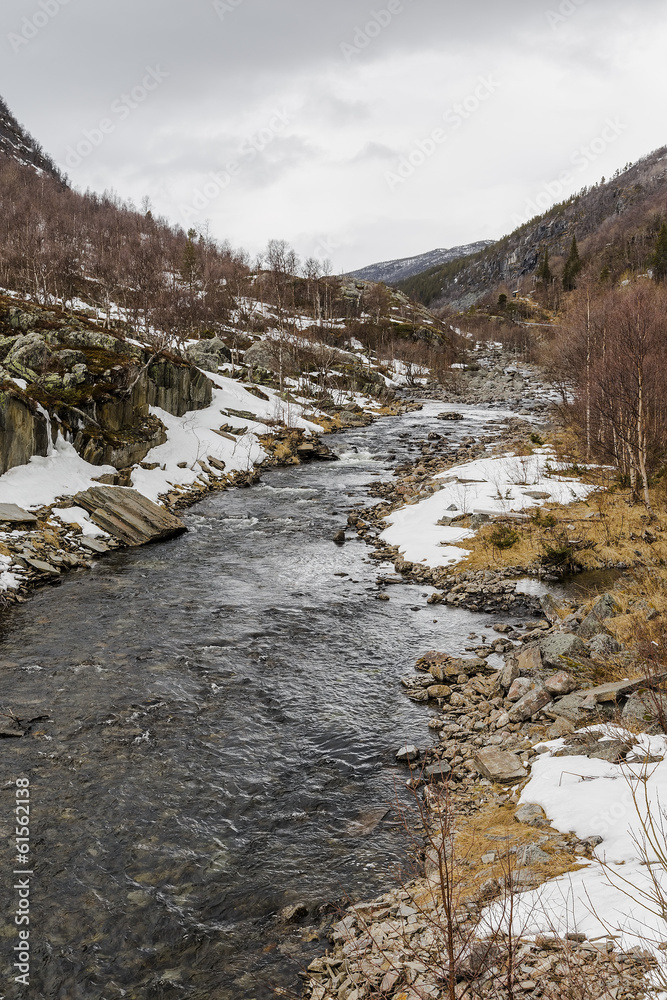 The mountain river with picturesque stone beaches The mountain river with picturesque stone beaches