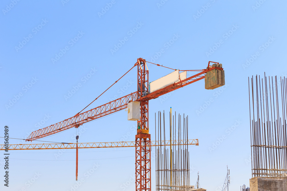 Building crane and construction site under   blue sky