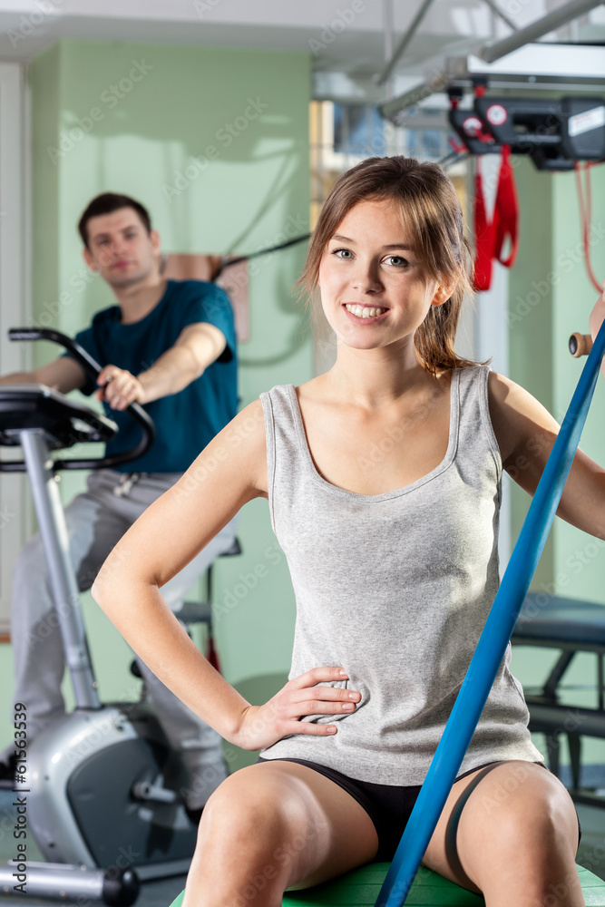 Fototapeta premium Smiling girl in fitness center