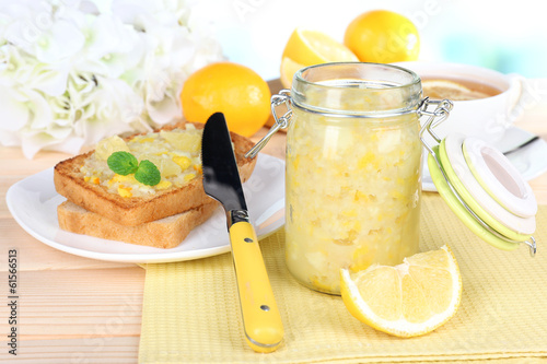 Fototapeta Naklejka Na Ścianę i Meble -  Delicious toasts with lemon jam on plate on table close-up