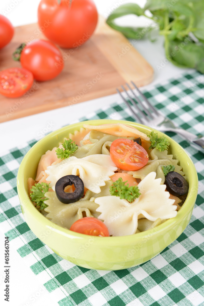 Delicious pasta with tomatoes on plate on table close-up Delicious pasta with tomatoes on plate on table close-up