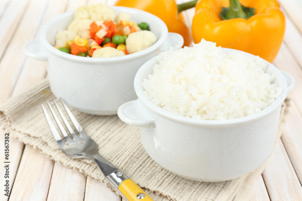 Cooked rice with vegetables on wooden table close up Cooked rice with vegetables on wooden table close up