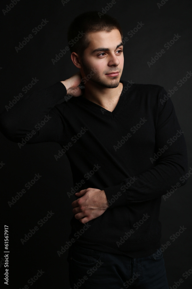 Handsome young man on dark background