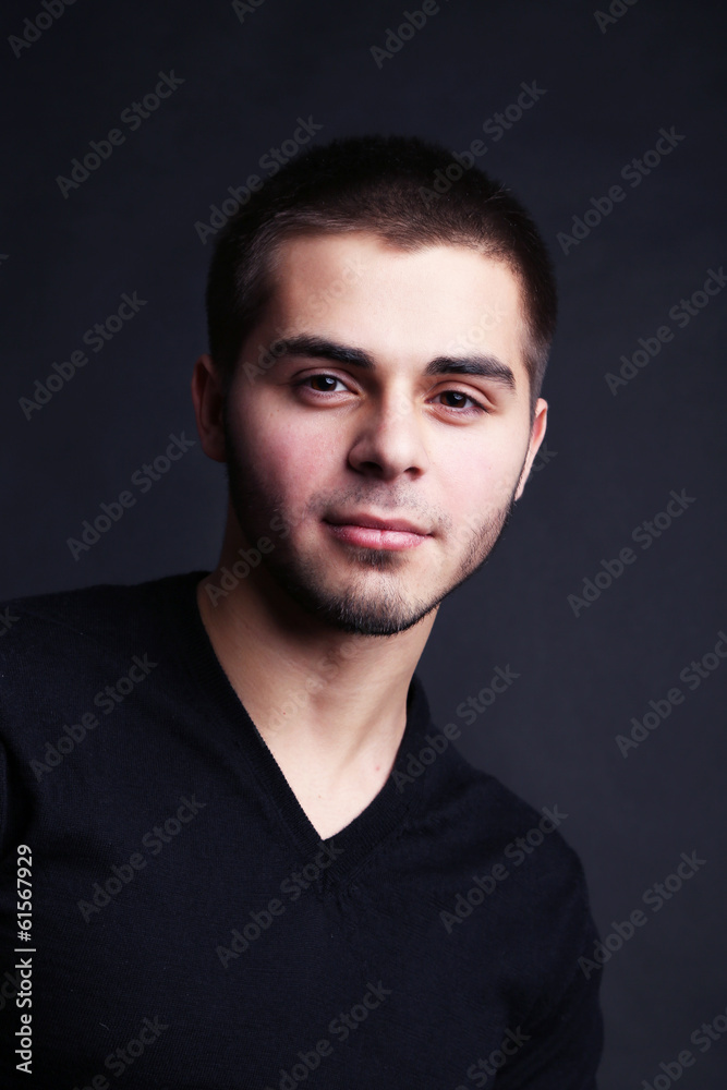 Handsome young man on dark background