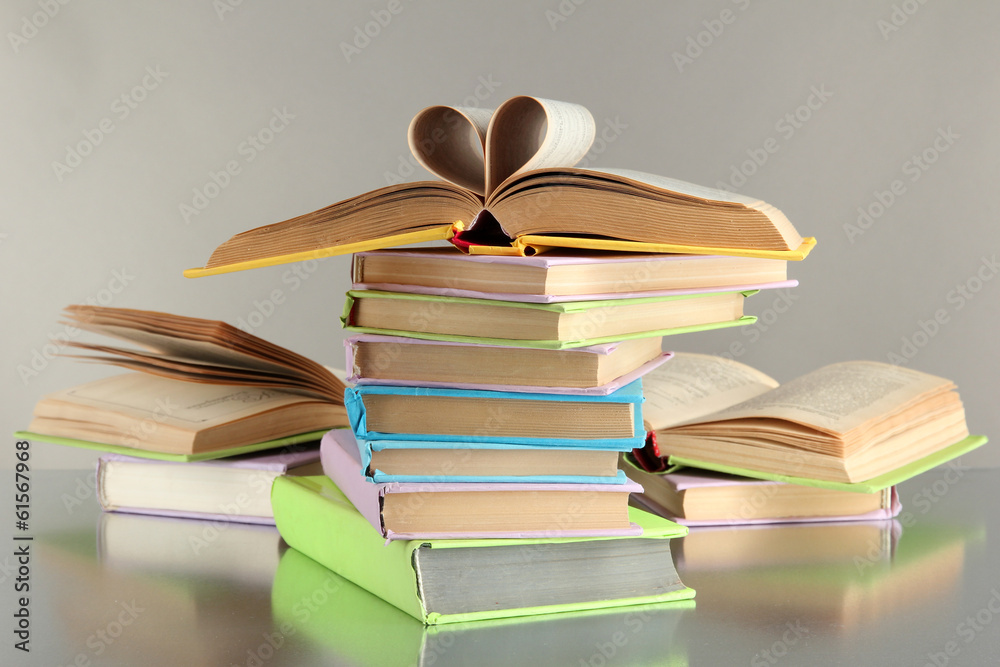 Fototapeta premium Stacks of books on grey background