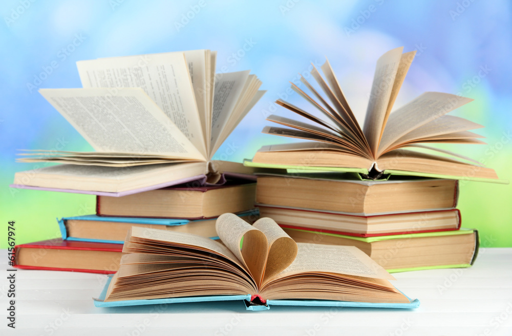 Stacks of books on table on natural background Stacks of books on table on natural background