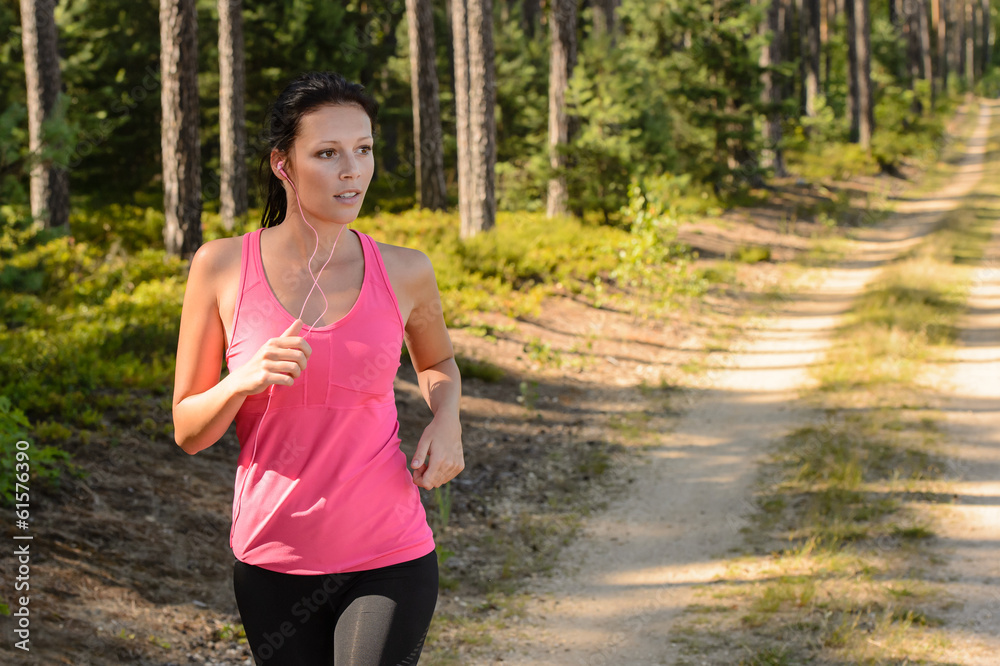 Woman running through forest outdoor training Woman running through forest outdoor training