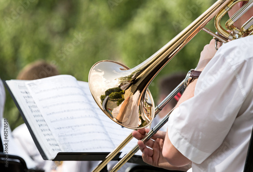 Men playing his trombone photo