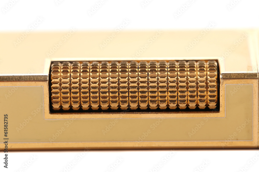 Metal flint golden on gas lighter. Metal flint golden on gas lighter.