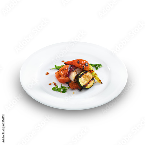 Healthy vegetarian grilled vegetables served on a white round pl