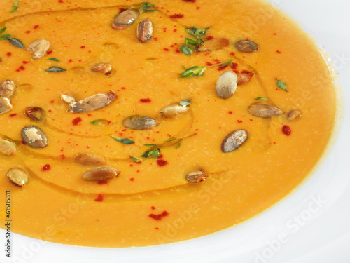 Hot healthy vegetarian pampkin cream soup with pampkin seeds in