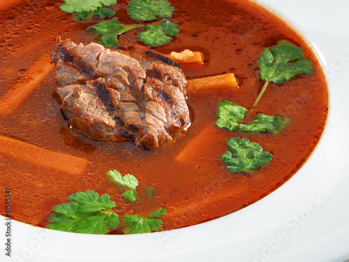 Hot delicious tomato soup with meat and rice served with leek an