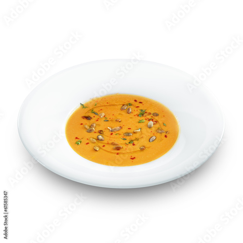 Hot healthy vegetarian pampkin cream soup with pampkin seeds in