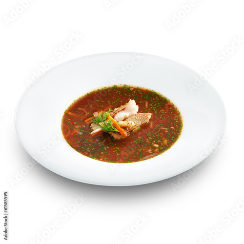 Hot delicious tomato soup with fish and rice served with leek an