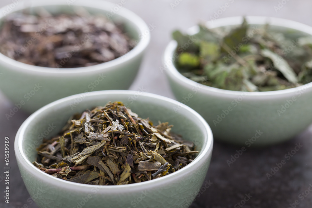 Different sorts of green tea in a green cup. Selective focus. Different sorts of green tea in a green cup. Selective focus.