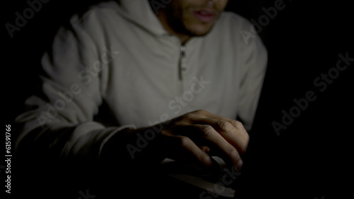 Man on laptop at night, concept of technology addiction