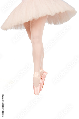 Ballet dancer standing on toes while dancing on white background