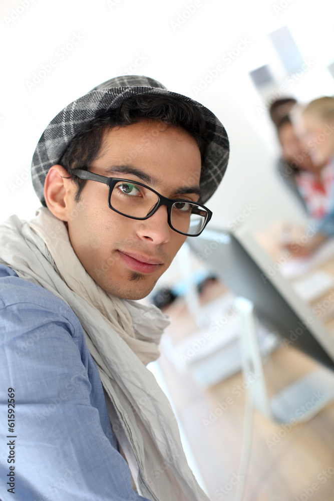 Portrait of smiling student with hat and eyeglasses Portrait of smiling student with hat and eyeglasses