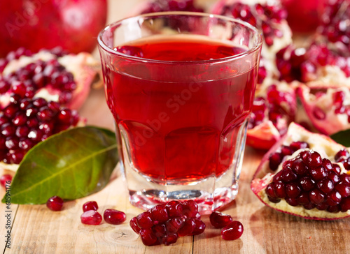 glass of pomegranate  juice with fresh fruits