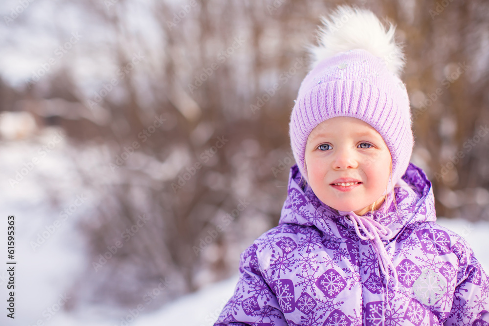 Portrait of Little cute happy girl having fun in the snow on a Portrait of Little cute happy girl having fun in the snow on a