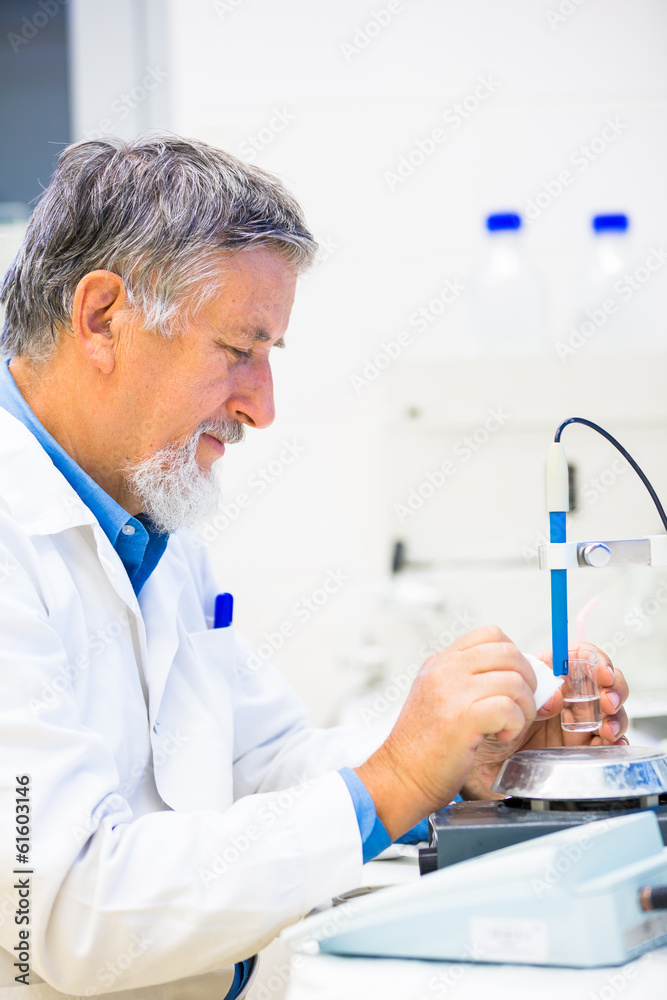 Senior male researcher carrying out scientific research in a lab Senior male researcher carrying out scientific research in a lab
