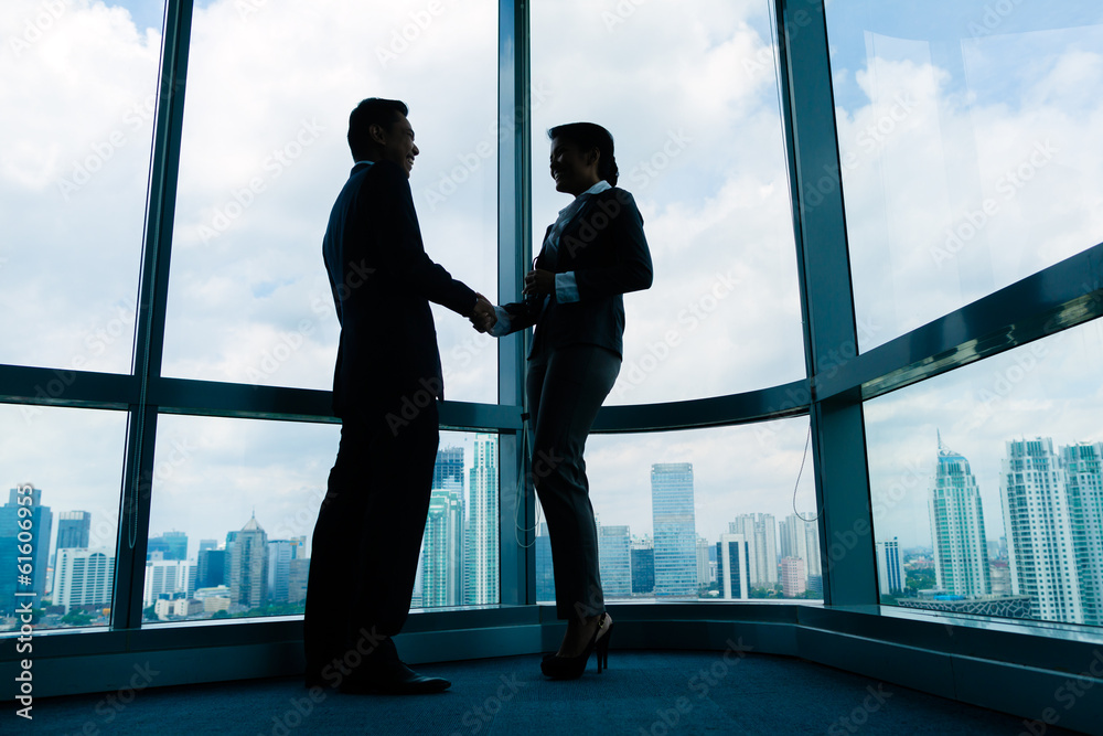 Asian business people shaking hands Asian business people shaking hands