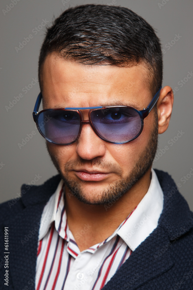 Portrait erious man wearing violet sunglasses Portrait erious man wearing violet sunglasses