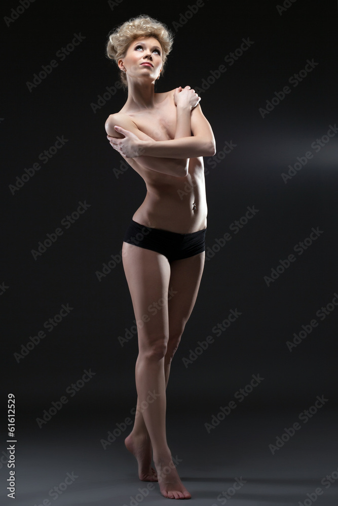 Image of lovely half-naked blonde posing in studio