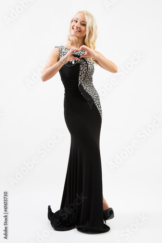 Beautiful female fashion model posing in black dress