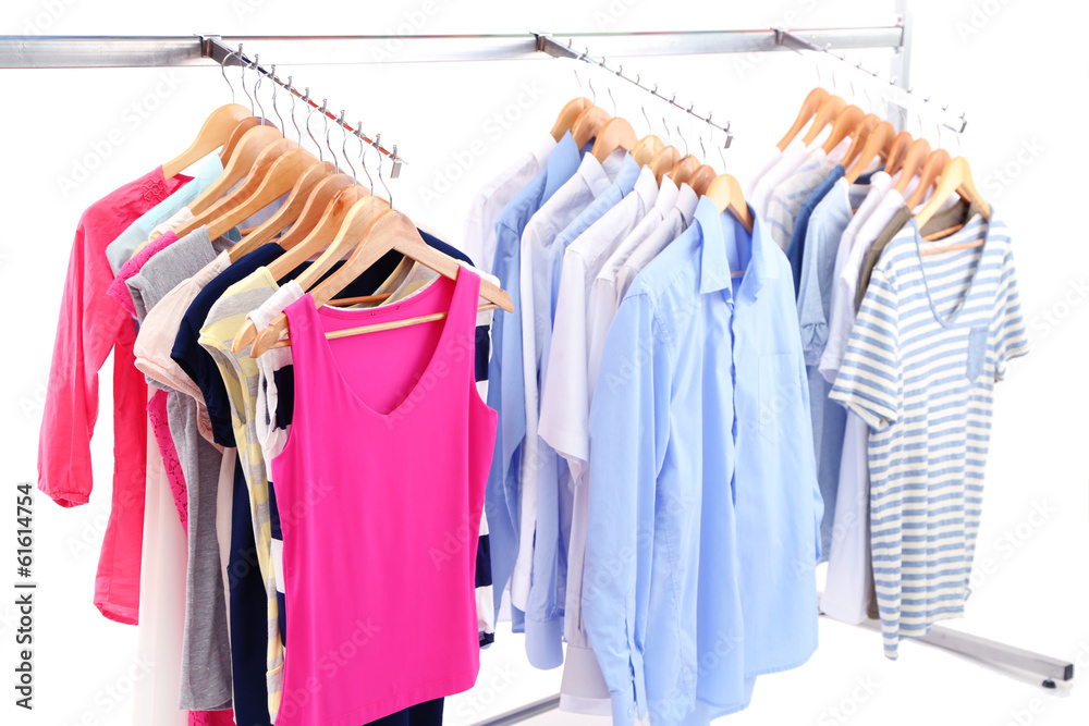 Different clothes on hangers, on gray background Different clothes on hangers, on gray background