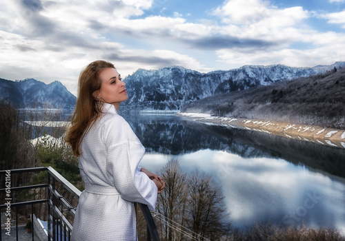 woman relaxes by looking at a mountain landscape © czamfir