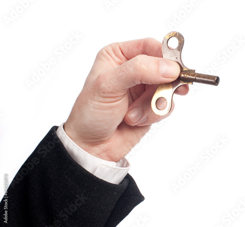 hand holding a key winder photo