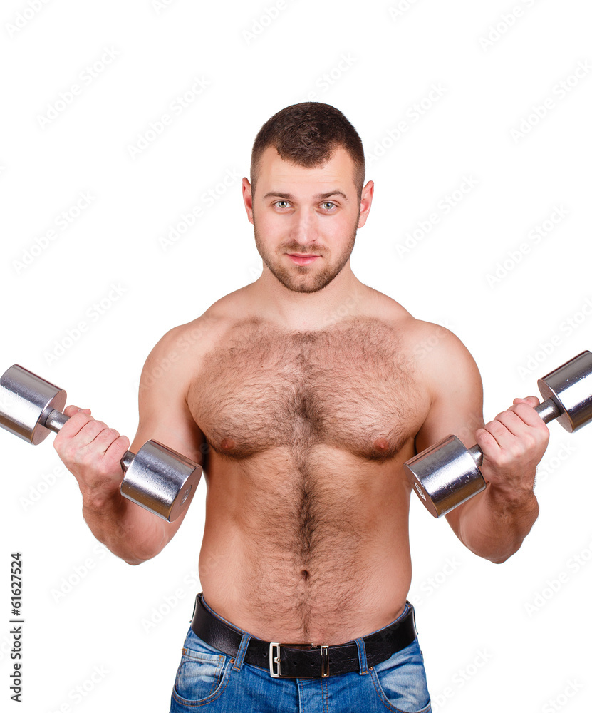 Muscular guy doing exercises with dumbbells on a white Muscular guy doing exercises with dumbbells on a white