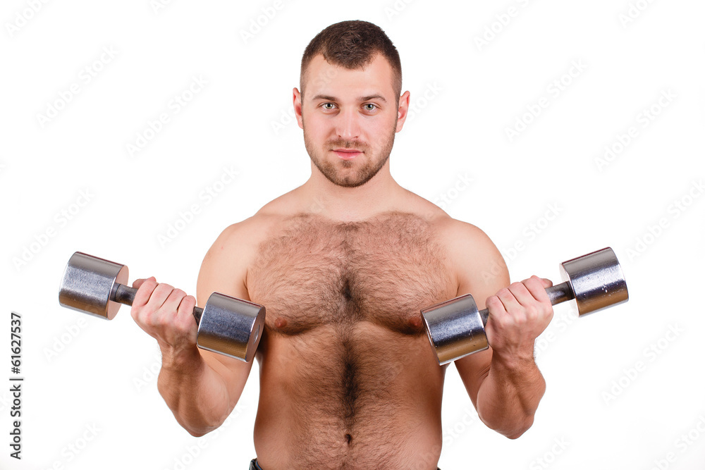 Muscular guy doing exercises with dumbbells on a white Muscular guy doing exercises with dumbbells on a white