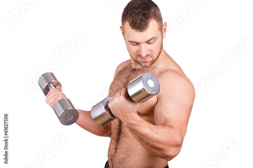 Muscular guy doing exercises with dumbbells on a white
